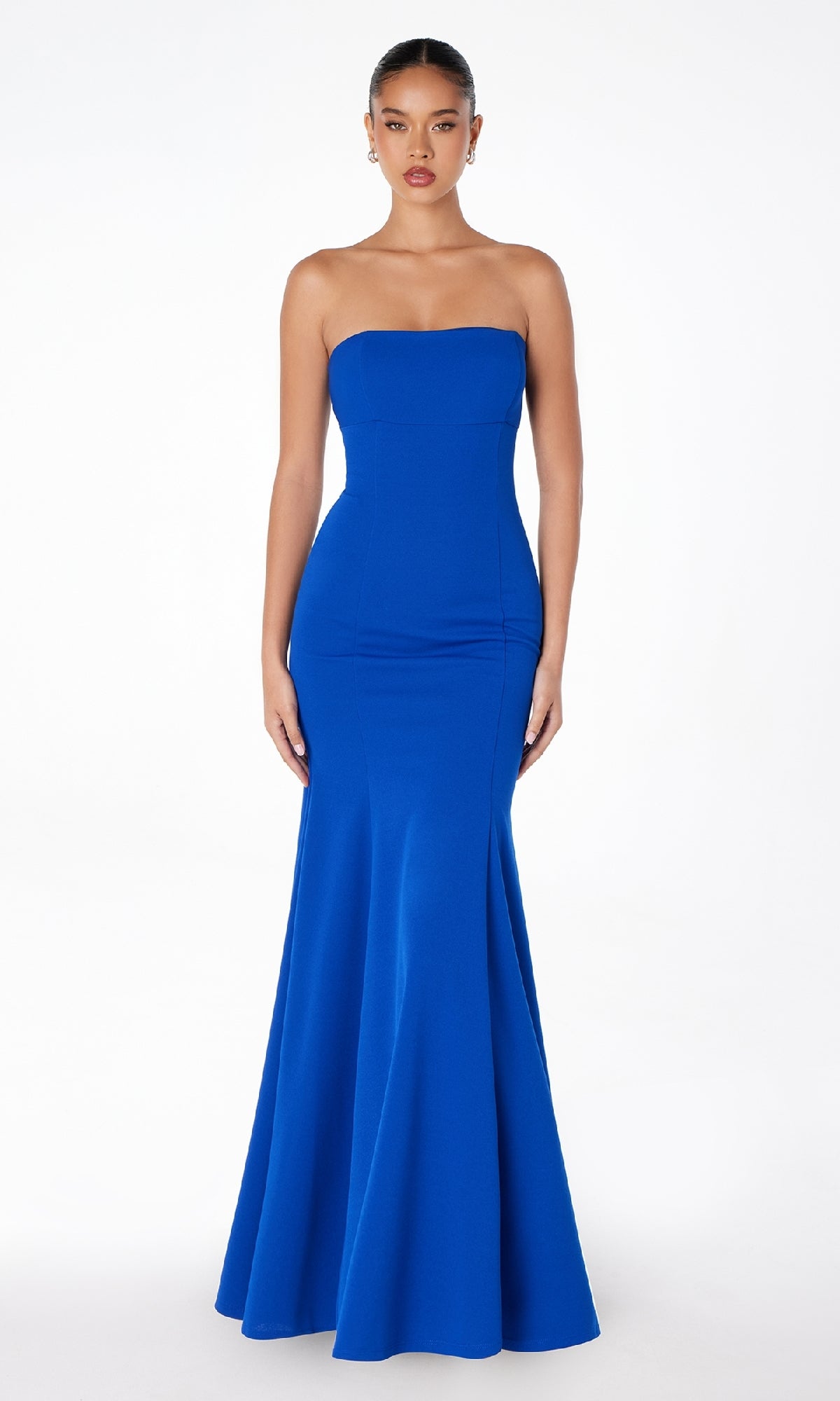 A woman stands facing forward in the Lace-Up Strapless Long Prom Dress: Astee T2010, a royal blue, form-fitting, floor-length gown, against a plain white background.